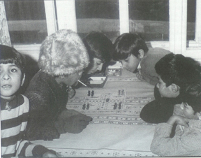 In the corner of one of the rooms of Austria's Traiskirchen transit centre, four youngsters enjoy a typical European game of Ludo (